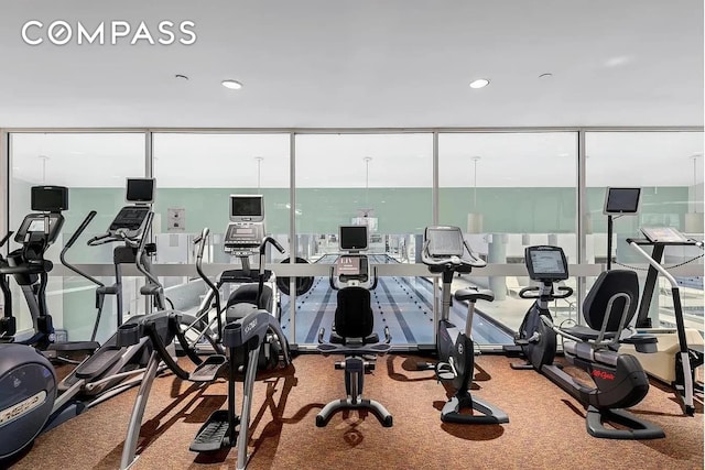 gym with plenty of natural light, recessed lighting, carpet, and floor to ceiling windows