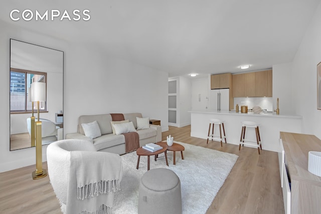 living room featuring light wood-style floors and baseboards