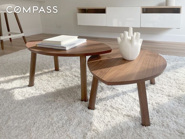 dining space with baseboards and wood finished floors
