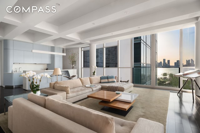 living area with beam ceiling, a wall of windows, coffered ceiling, and wood finished floors