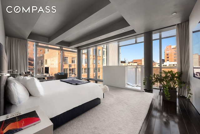 bedroom with wood finished floors and floor to ceiling windows