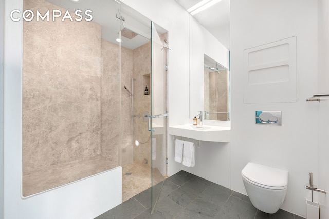 full bath featuring tile patterned floors, toilet, and a walk in shower