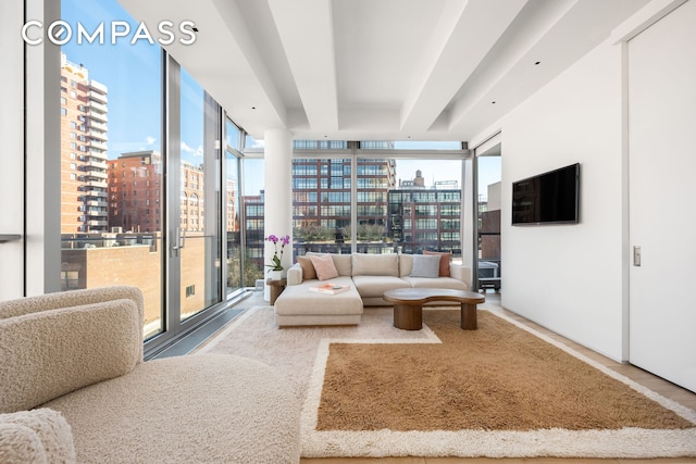 living room featuring floor to ceiling windows and a view of city