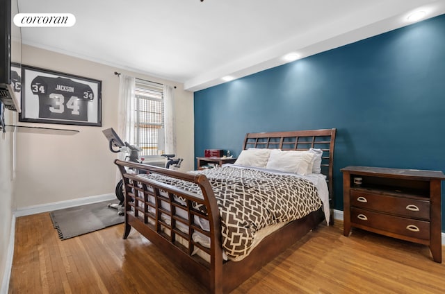 bedroom featuring wood finished floors and baseboards