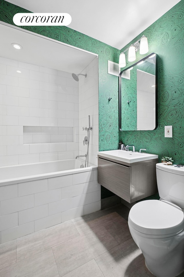 7 E 14th St Unit 1406, New York City, NY 10003 - bathroom featuring tiled shower / bath combo, vanity, toilet, tile patterned flooring, and wallpapered walls
