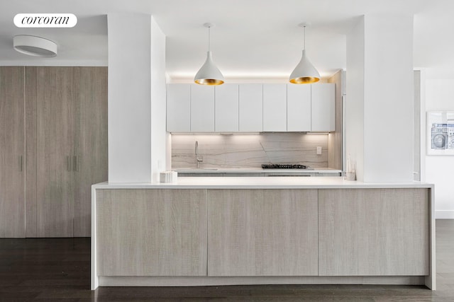 7 E 14th St Unit 1406, New York City, NY 10003 - kitchen with modern cabinets, a sink, light countertops, tasteful backsplash, and dark wood-style floors