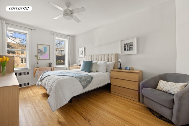 bedroom with visible vents, radiator, a ceiling fan, and light wood finished floors