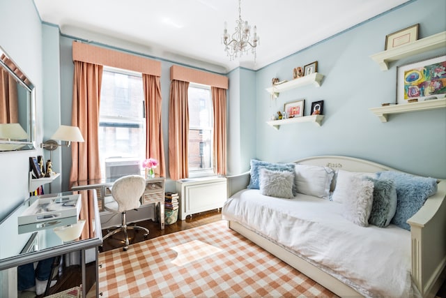 114 E 84th St Unit 8B, New York City, NY 10028 - bedroom with cooling unit, an inviting chandelier, and wood finished floors