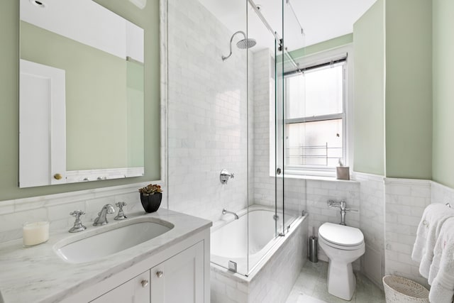 114 E 84th St Unit 8B, New York City, NY 10028 - full bath featuring tile patterned floors, tile walls, toilet, vanity, and tub / shower combination