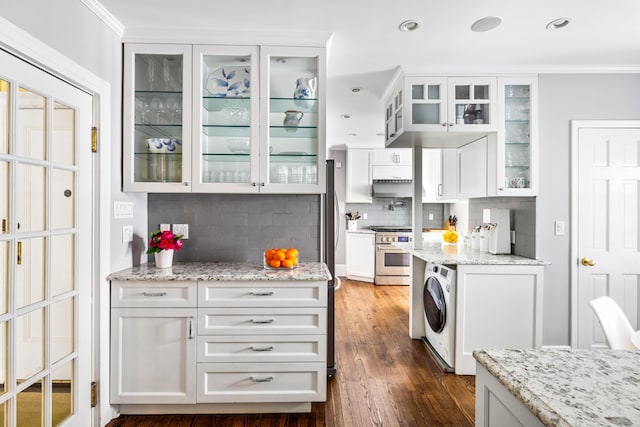114 E 84th St Unit 8B, New York City, NY 10028 - kitchen featuring ornamental molding, high end stainless steel range oven, tasteful backsplash, and washer / clothes dryer