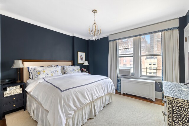 114 E 84th St Unit 8B, New York City, NY 10028 - bedroom featuring wood finished floors and a notable chandelier