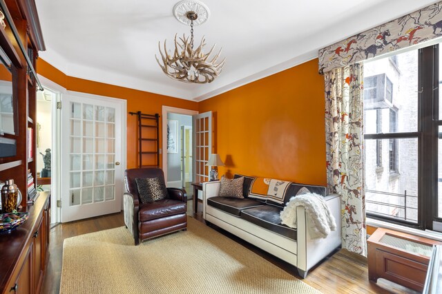 114 E 84th St Unit 8B, New York City, NY 10028 - living area with a chandelier, french doors, plenty of natural light, and wood finished floors