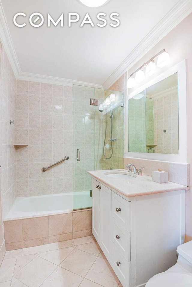 full bath with tiled shower / bath, vanity, ornamental molding, and toilet