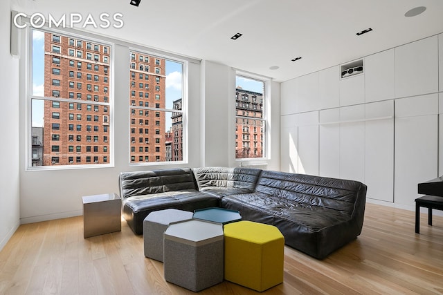 living area with wood finished floors and baseboards