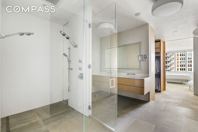 ensuite bathroom with tiled shower and vanity