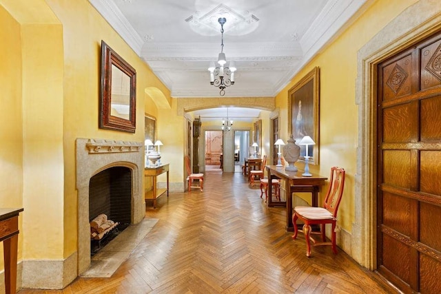 hall featuring ornamental molding, baseboards, arched walkways, and a notable chandelier