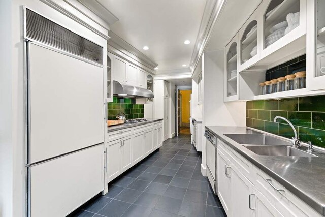 983 Park Ave Unit 3B, New York City, NY 10028 - kitchen featuring built in fridge, crown molding, under cabinet range hood, dark tile patterned flooring, and white cabinets