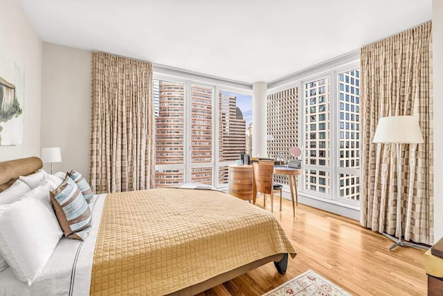bedroom with wood finished floors and a city view