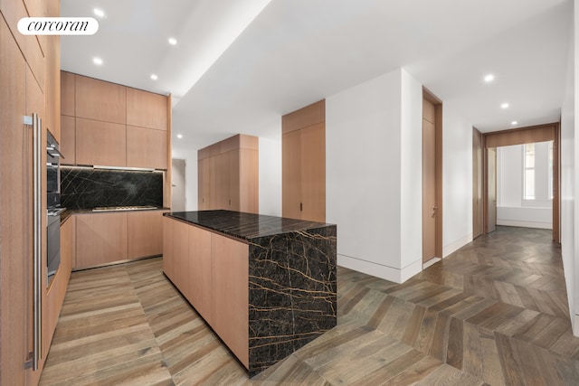 kitchen featuring recessed lighting, modern cabinets, backsplash, and light brown cabinetry