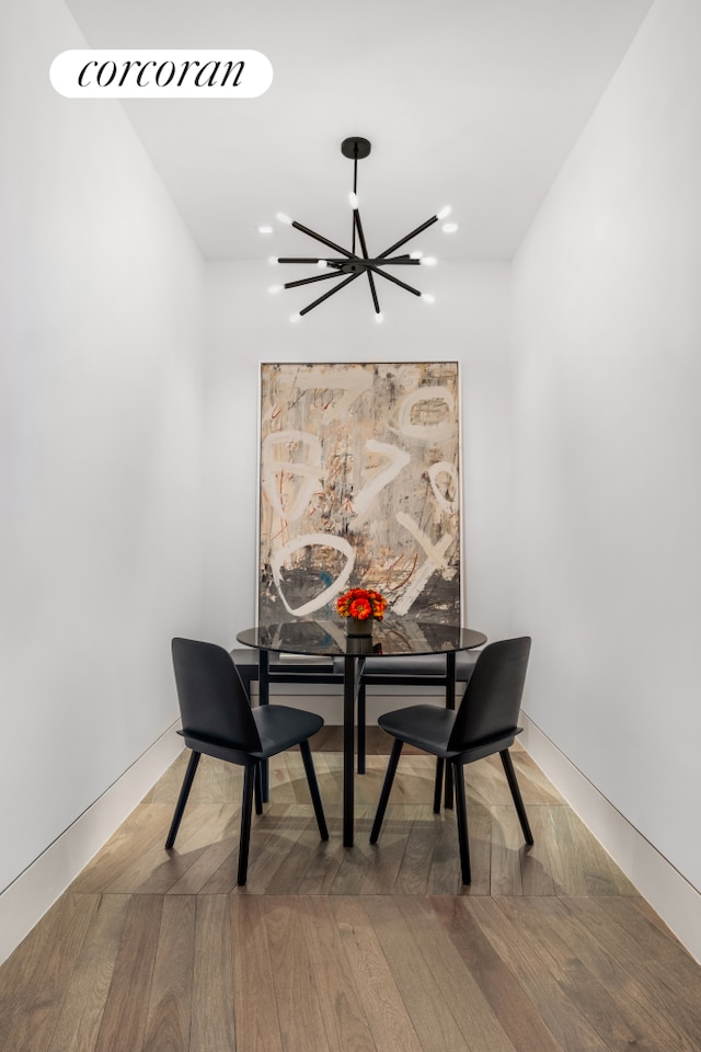 dining room with wood finished floors, a notable chandelier, and recessed lighting