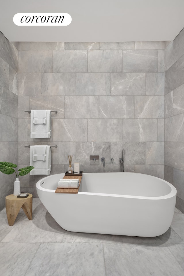 full bath with tile walls and a freestanding bath