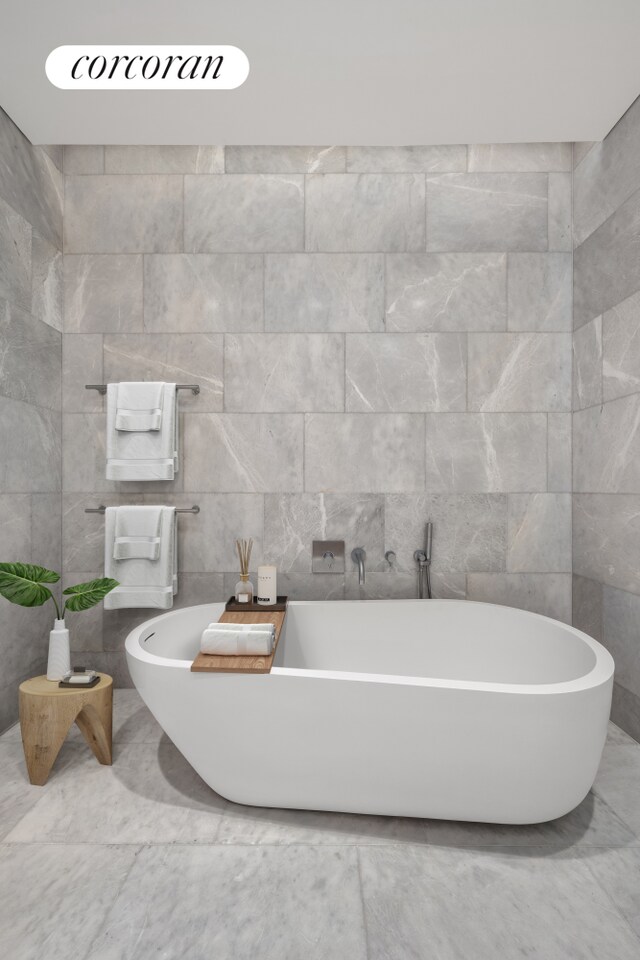 49 Chambers St Unit 5D, New York City, NY 10007 - full bathroom featuring tile walls and a soaking tub
