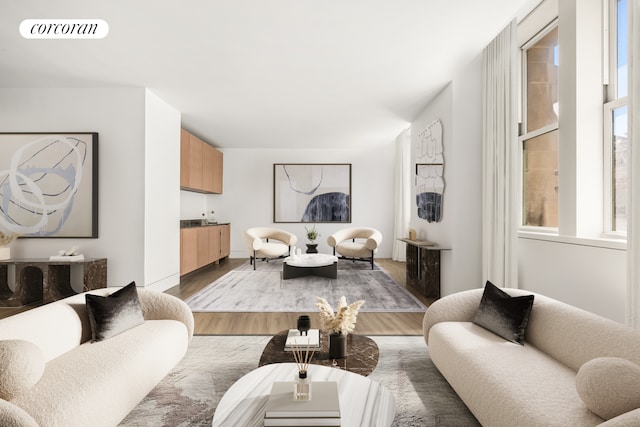living room with visible vents and light wood-style flooring