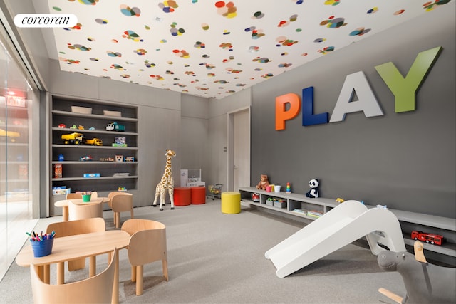 recreation room featuring carpet floors and visible vents