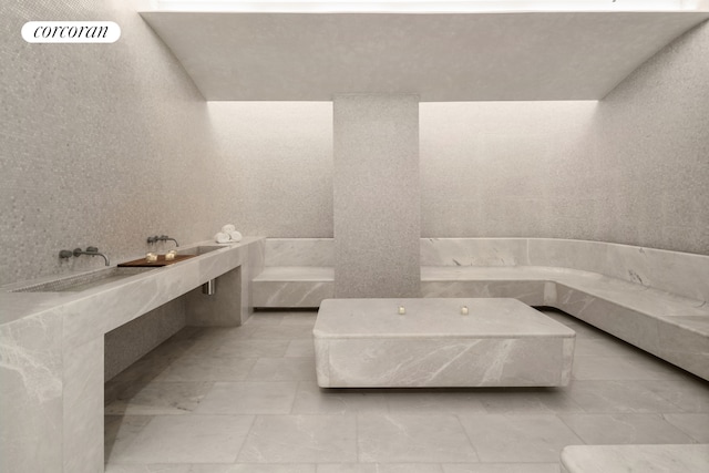 bathroom with a bath and tile patterned floors
