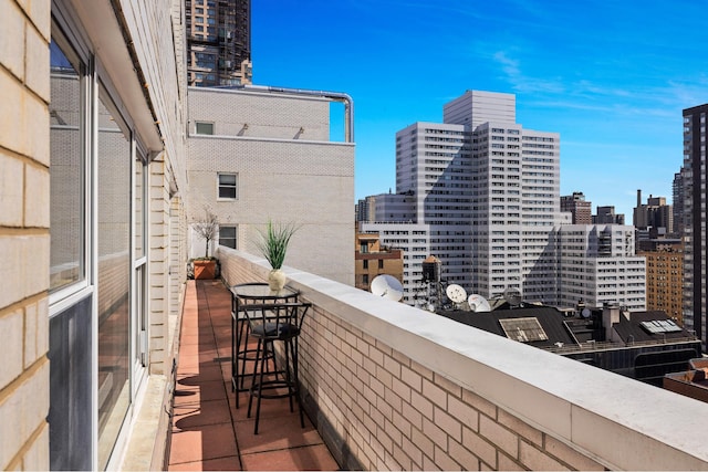 balcony with a bar and a view of city