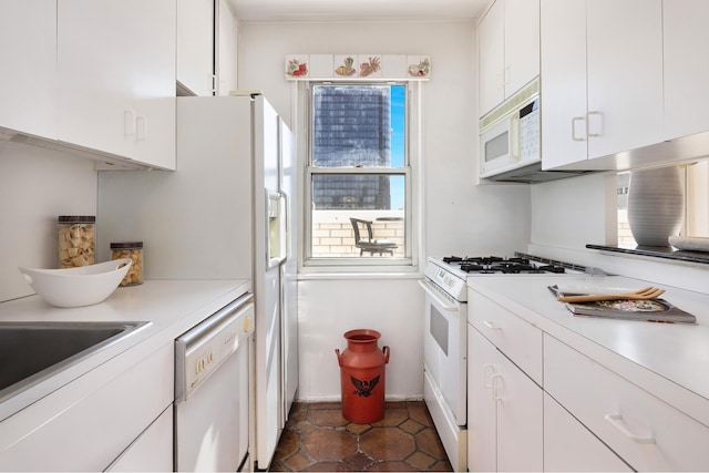kitchen with light countertops, baseboards, white cabinetry, and white appliances