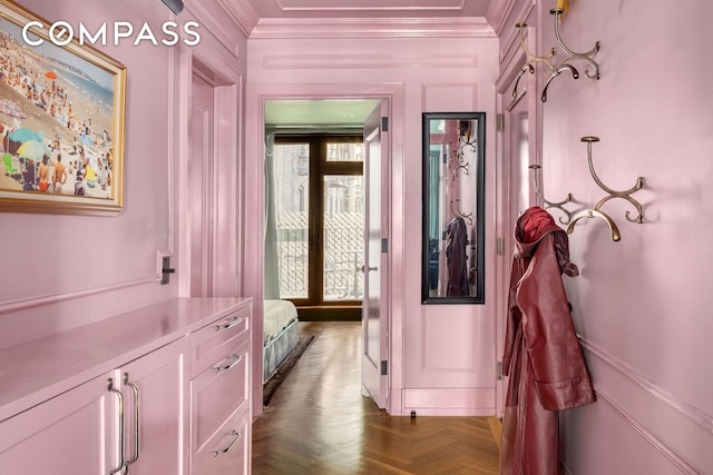 corridor featuring ornamental molding and a decorative wall