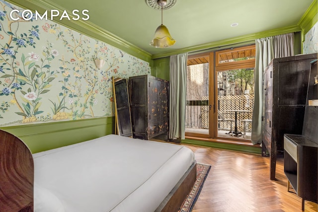 bedroom featuring wallpapered walls, crown molding, and a wainscoted wall