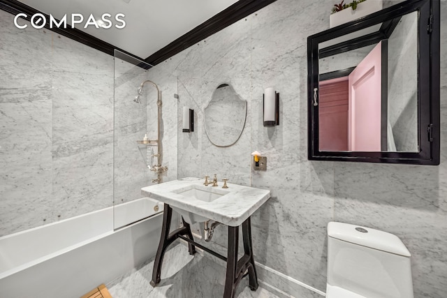 bathroom featuring ornamental molding, toilet, tile walls, and tub / shower combination
