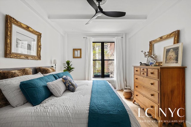 bedroom featuring light wood-style floors, ceiling fan, and crown molding