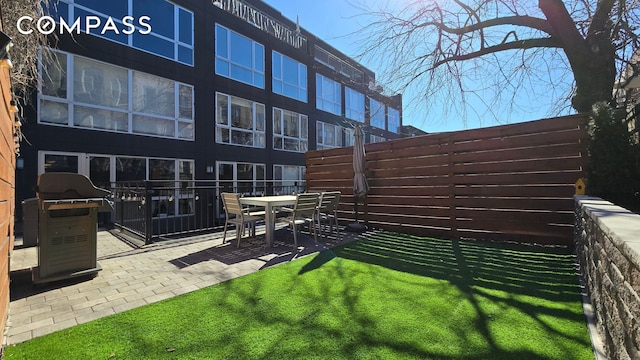 view of yard with fence and a patio area