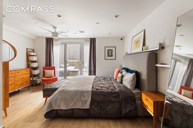 bedroom featuring light wood-type flooring, visible vents, and access to exterior
