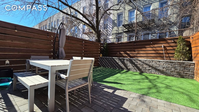 view of patio / terrace with outdoor dining area and fence
