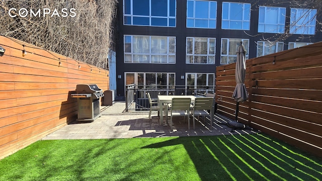 view of patio with a fenced backyard and area for grilling