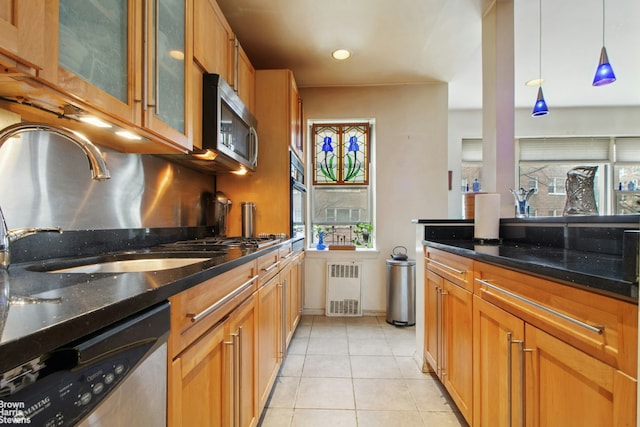 3850 Hudson Manor Ter Unit 1Ee/2Ee, New York City, NY 10463 - kitchen featuring appliances with stainless steel finishes, a sink, light tile patterned floors, and dark stone counters