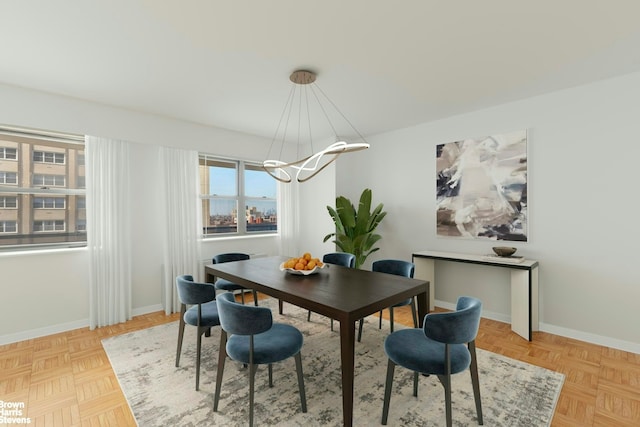 dining area with baseboards and a notable chandelier