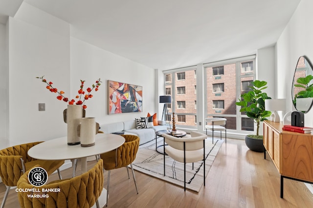 living room with floor to ceiling windows and light wood-type flooring