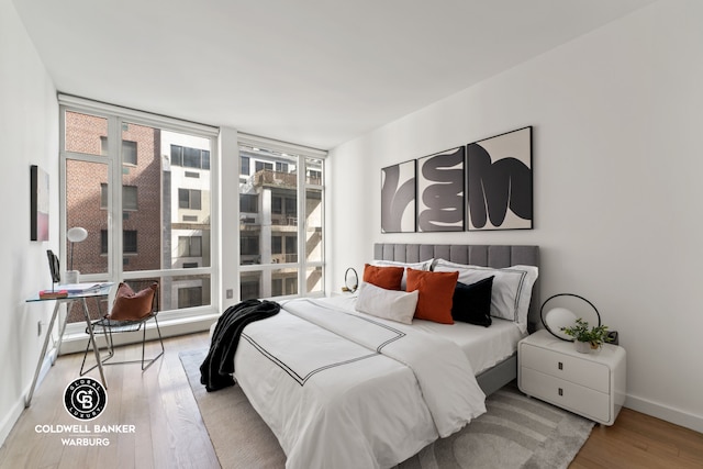 bedroom featuring baseboards and wood finished floors