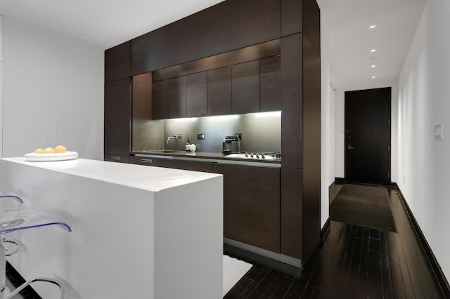 20 Pine St Unit 516, New York City, NY 10005 - kitchen with modern cabinets, dark wood-type flooring, dark brown cabinets, and recessed lighting