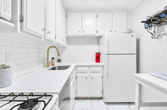 520 E 72nd St Unit 9C, New York City, NY 10021 - kitchen with freestanding refrigerator, a sink, stainless steel dishwasher, and white cabinetry