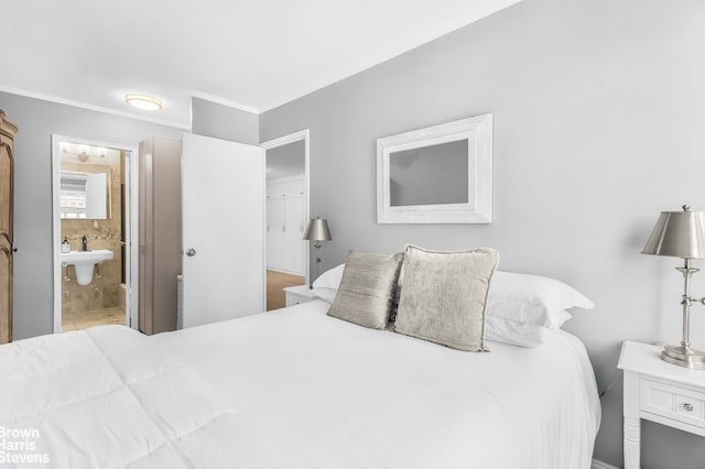 520 E 72nd St Unit 9C, New York City, NY 10021 - bedroom featuring ensuite bath, crown molding, and a sink