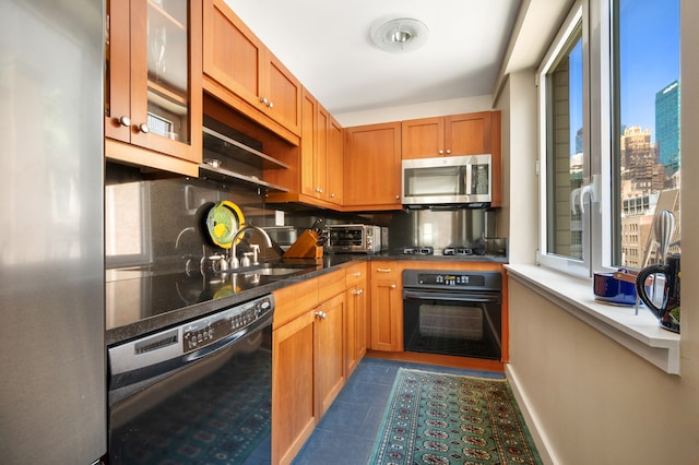 425 5th Ave Unit 19A, New York City, NY 10016 - kitchen featuring black appliances, healthy amount of natural light, tasteful backsplash, and a sink