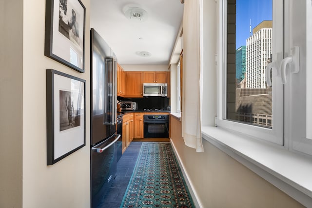 425 5th Ave Unit 19A, New York City, NY 10016 - kitchen with black appliances and baseboards