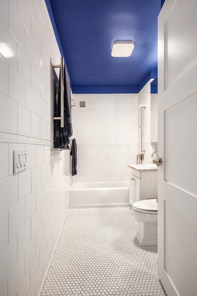425 5th Ave Unit 19A, New York City, NY 10016 - full bath with tile patterned flooring, toilet, tile walls, shower / bathtub combination, and vanity