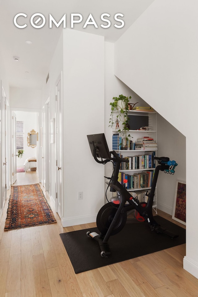 workout area with wood finished floors and baseboards